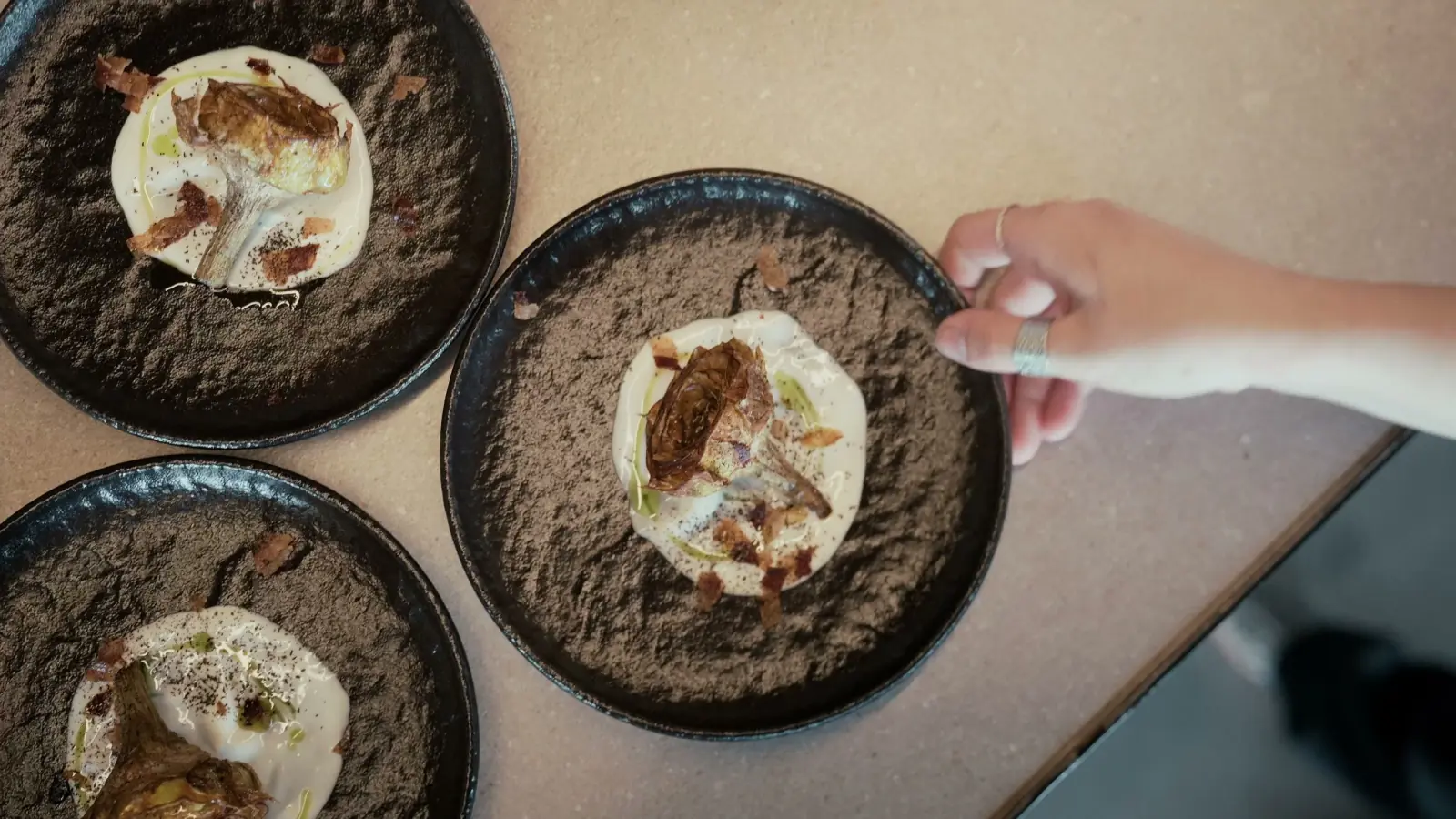 Artichoke plates served one by one, seen from above